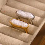 gold plated and silver-finish pearl cocktail rings in a display tray