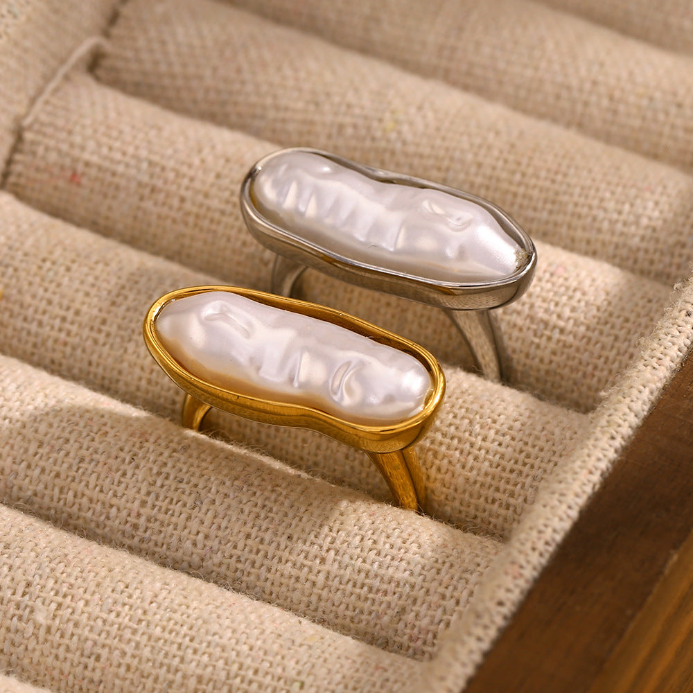gold plated and silver-finish pearl cocktail rings in a display tray