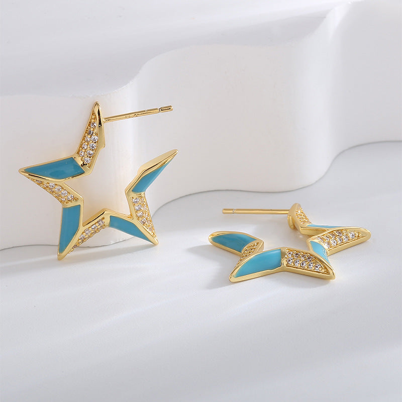 open star stud earrings with blue resin and clear zirconia details