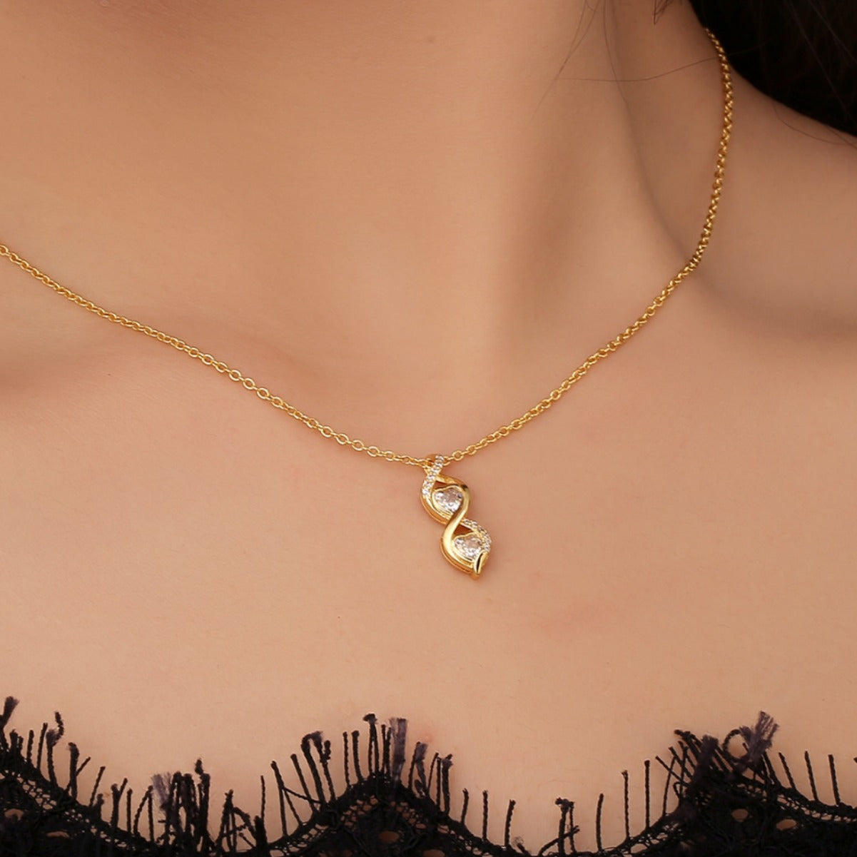 gold plated double twist clear stone necklace worn at the collarbone
