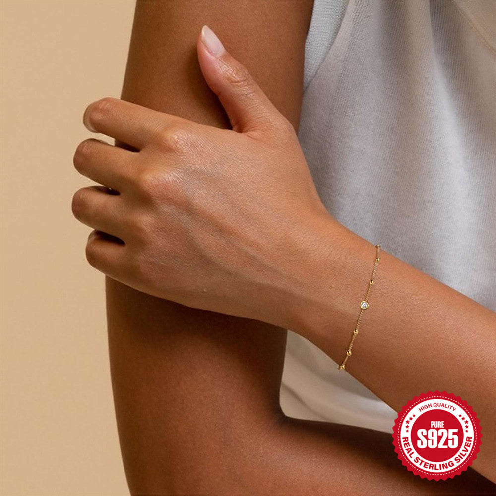 925 Sterling Silver Beaded Zirconia Station Bracelet — gold bracelet worn beside light top