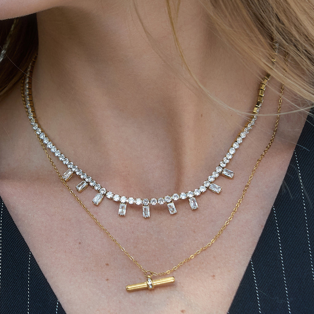 Clear drop necklace layered with a bar pendant