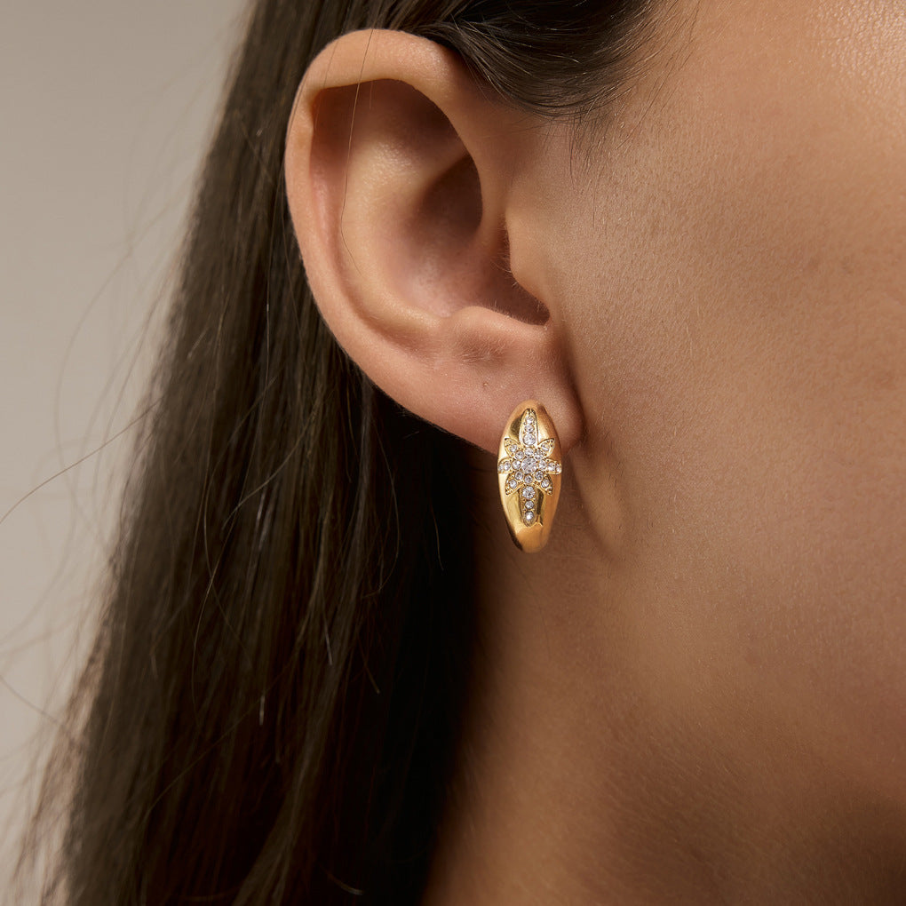 Oval celestial hoop worn in a profile view