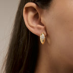 Oval celestial hoop worn in a profile view