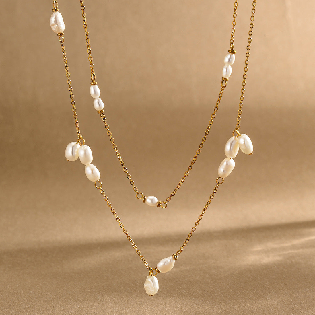 White bead station necklaces displayed at different heights