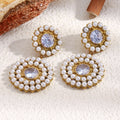 gold plated pearl halo drop earrings with clear round zirconia centers