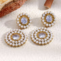 gold plated pearl halo drop earrings with clear round zirconia centers