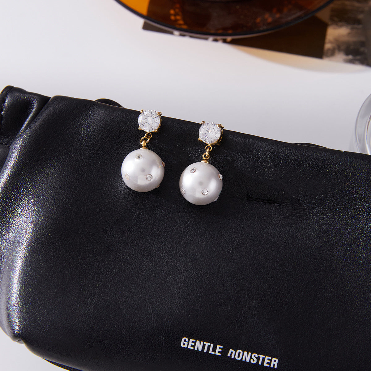 Imitation Pearl and Clear Stone Stainless Steel Drop Earrings — paired earrings on a neutral surface