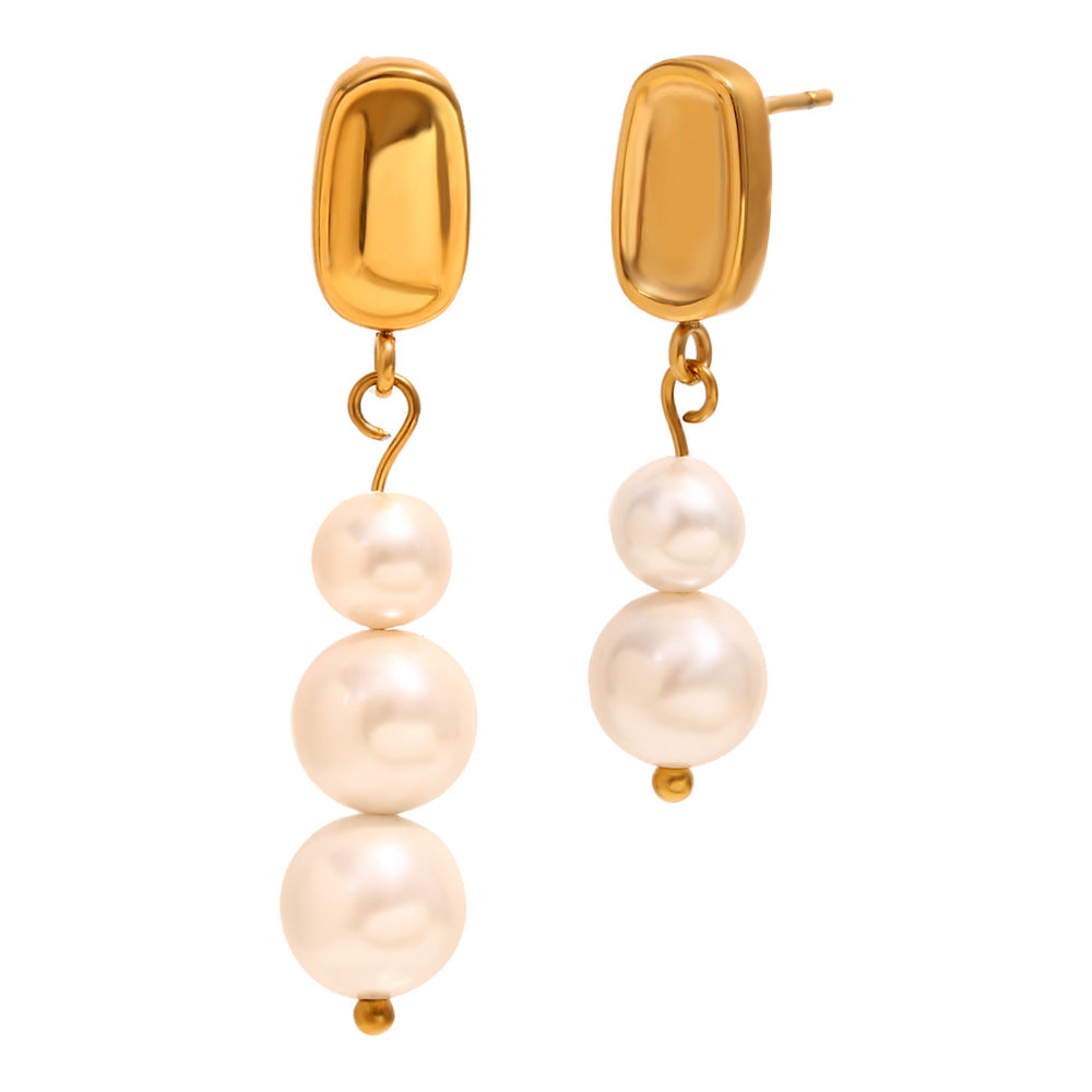 isolated pair of asymmetrical stainless steel pearl drops