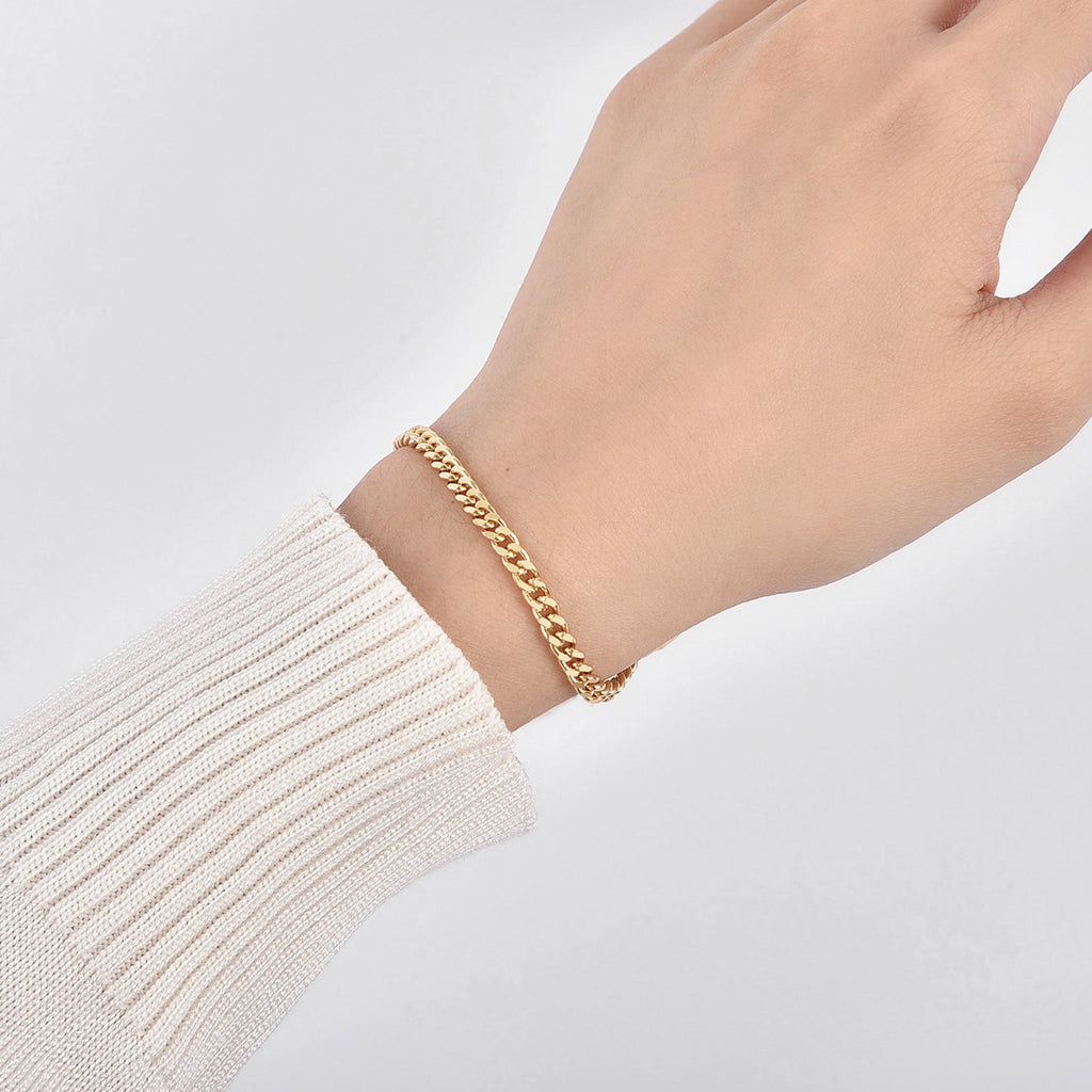 close wrist view of polished gold plated Cuban chain bracelet