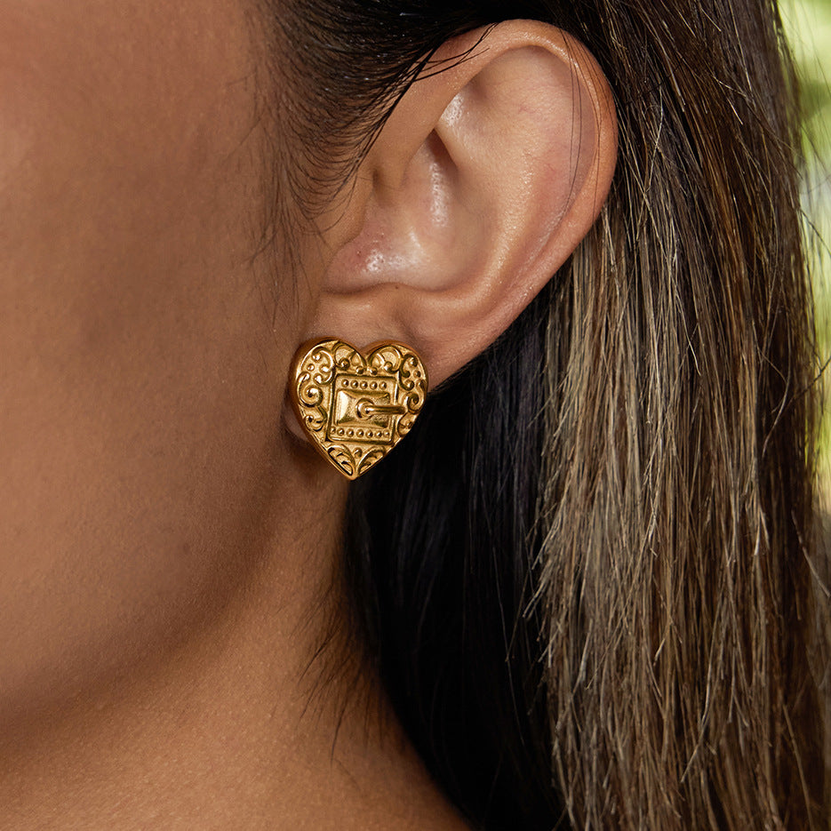 Embossed heart stud earrings worn view