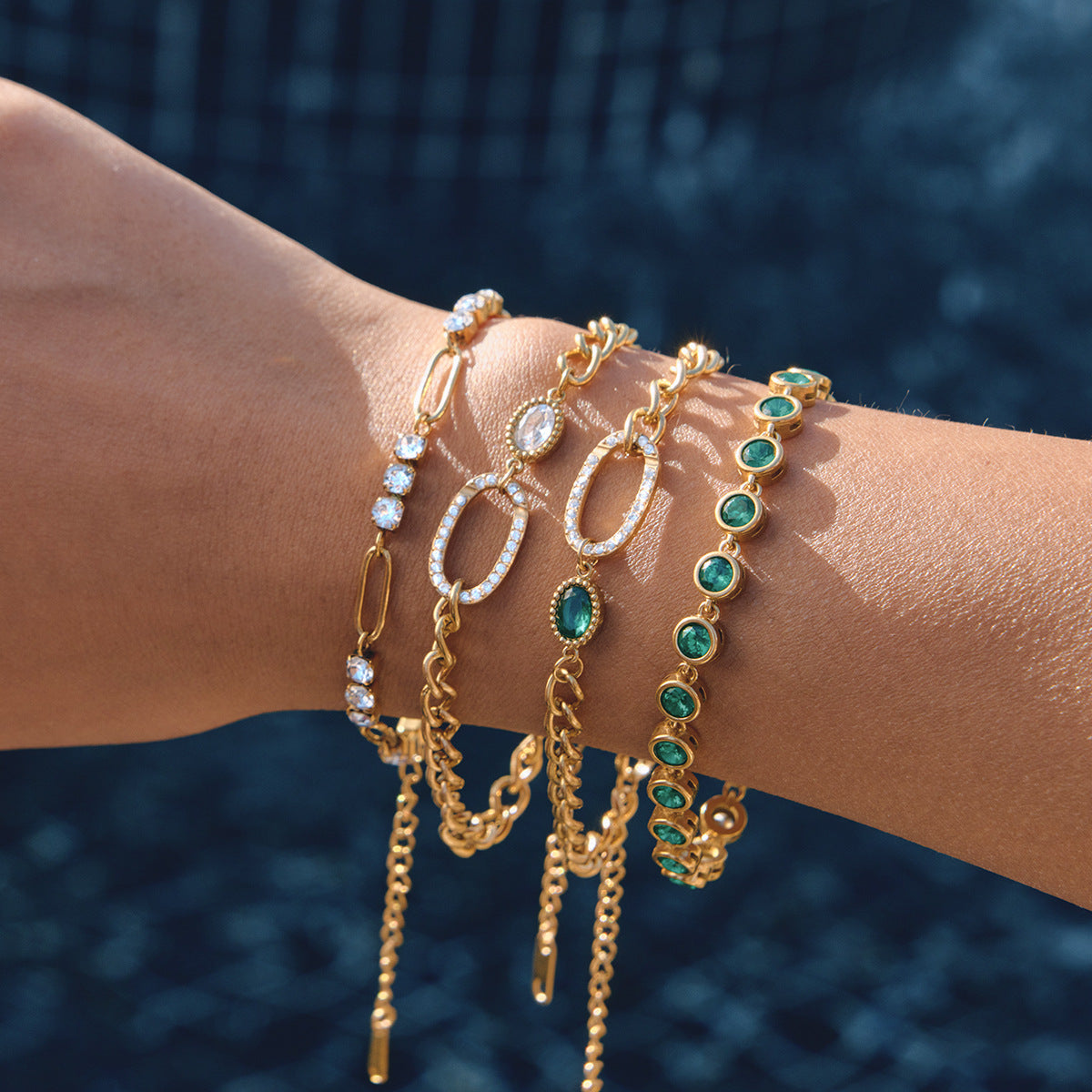 Green and clear bracelets layered on a wrist