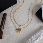 Gold Tone Blue Cabochon Stainless Steel Equestrian Necklaces — styled view of both necklace designs