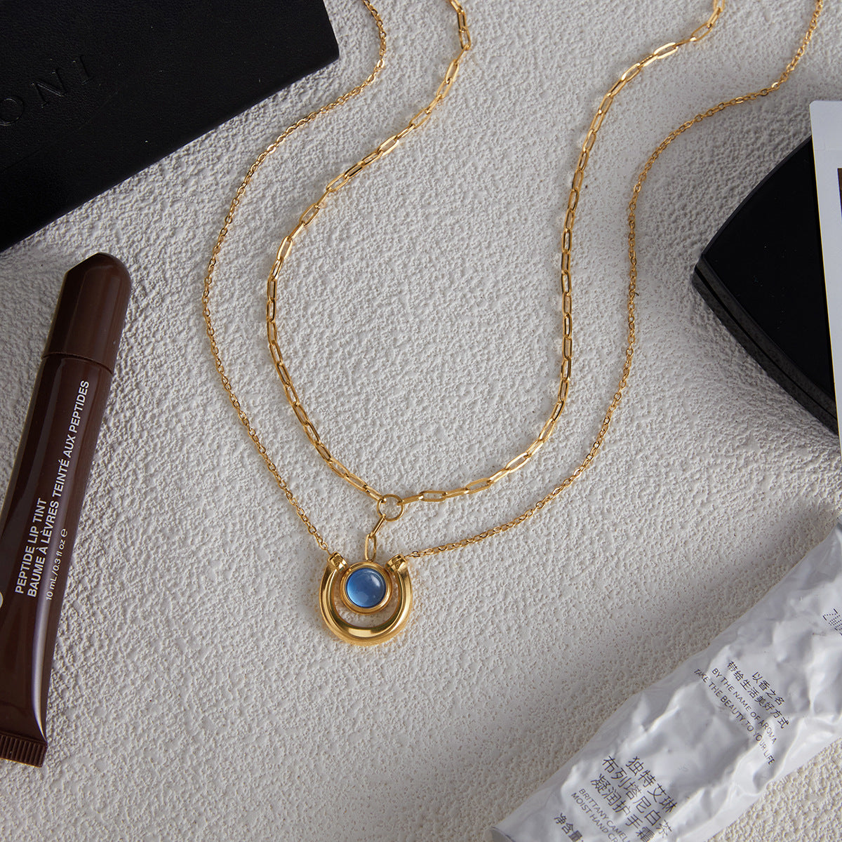 Gold Tone Blue Cabochon Stainless Steel Equestrian Necklaces — styled view of both necklace designs