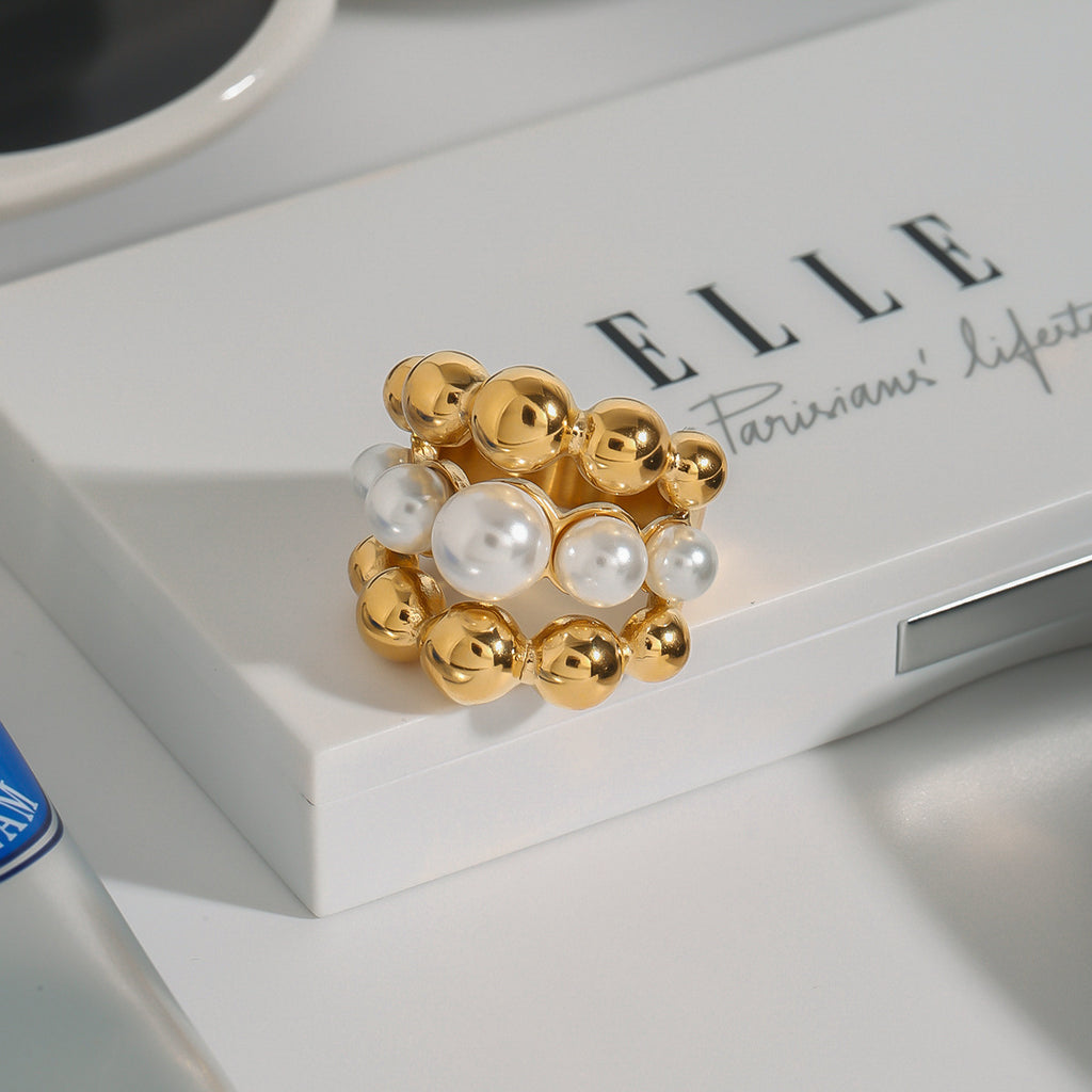Graduated bead statement ring styled on a white surface