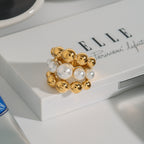 Graduated bead statement ring styled on a white surface