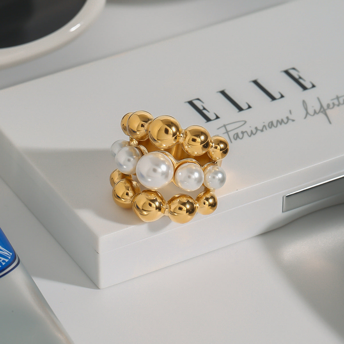 Graduated bead statement ring styled on a white surface
