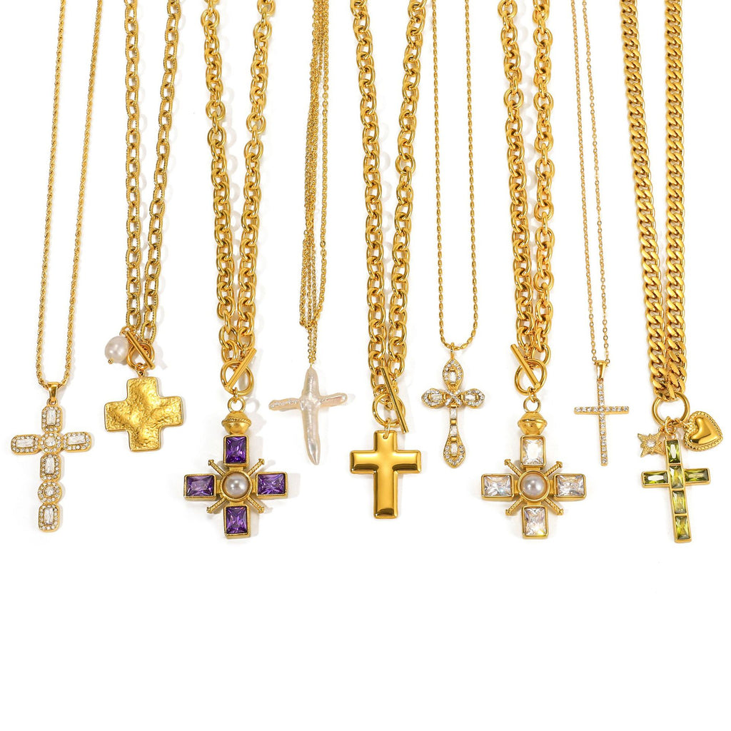 Cross pendant necklace assortment showing varied chain profiles and decorative accents