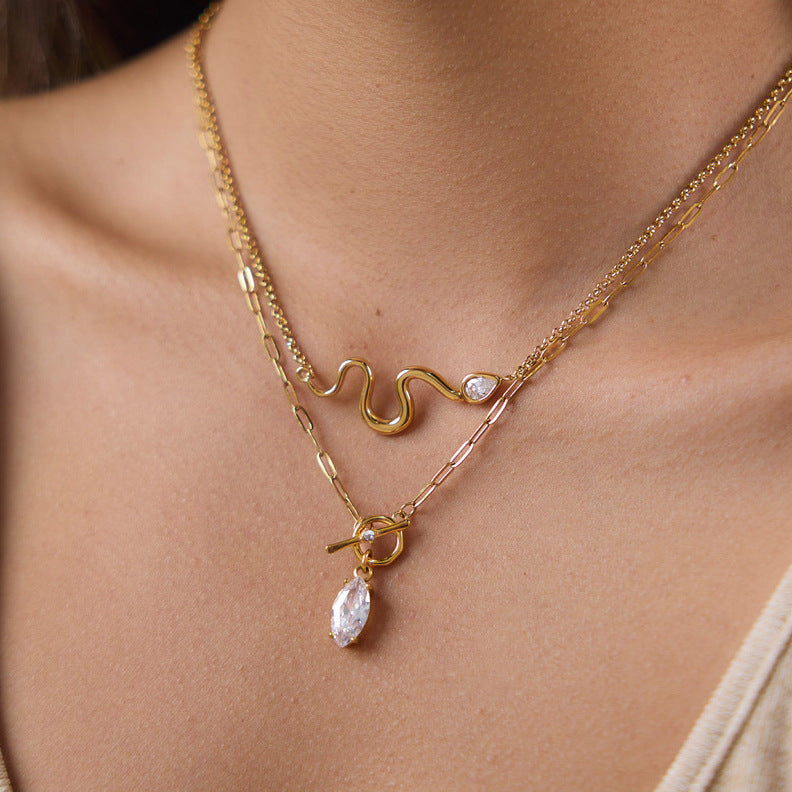 Toggle pendant and sculpted wave necklaces layered together
