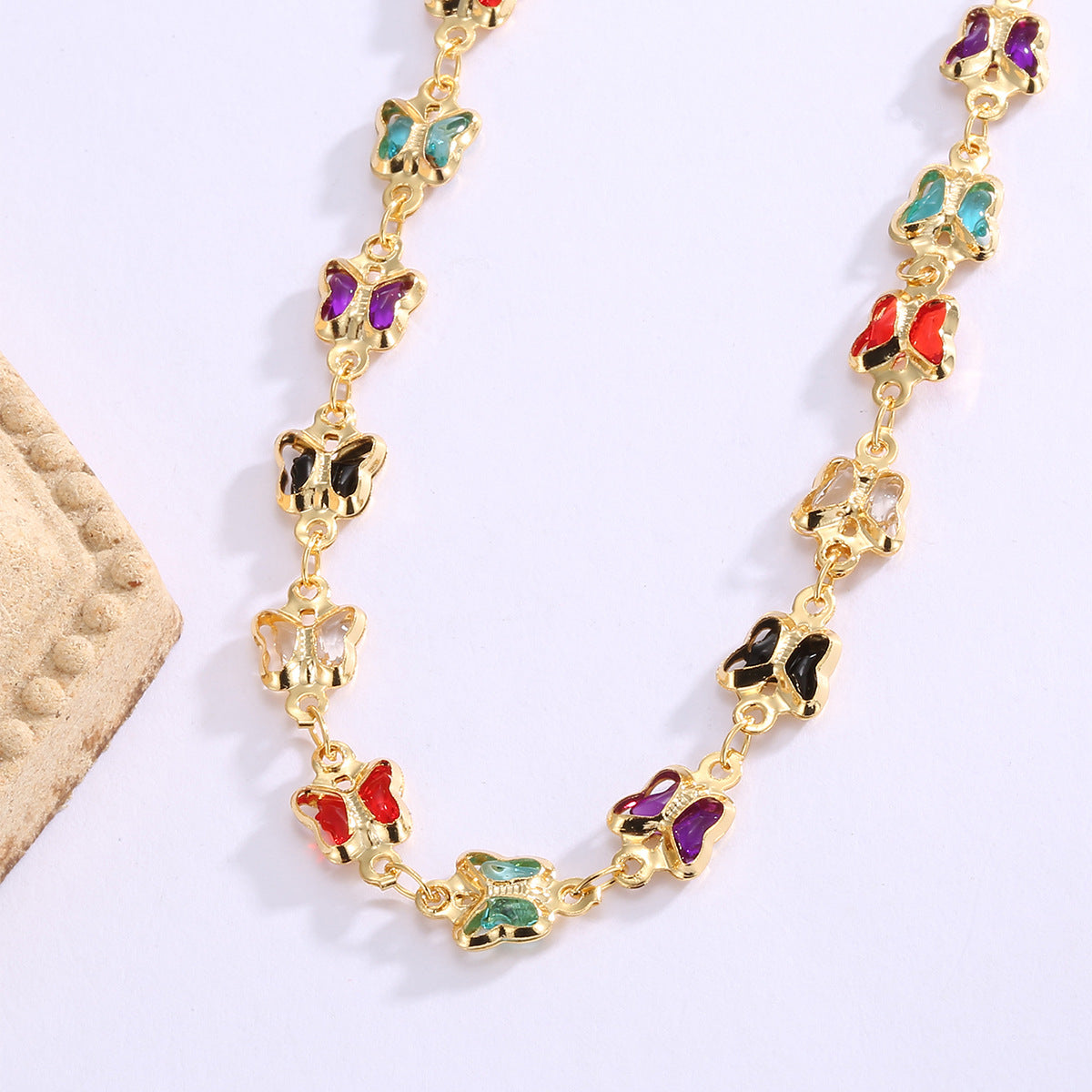 close view of red blue purple and black acrylic butterfly necklace