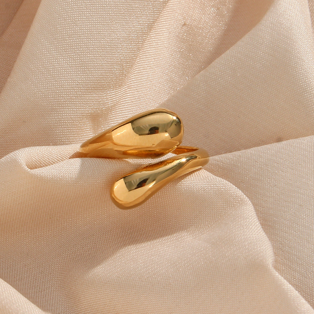 Polished gold-tone teardrop ends on pale fabric