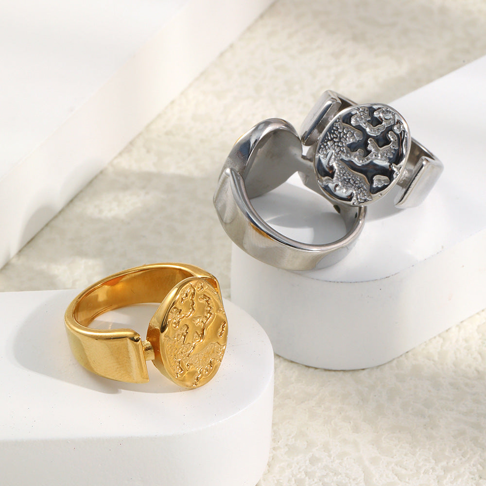 gold plated and silver-finish celestial relief signet rings in a styled display