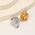 two-finish stainless steel statement rings on a stone display