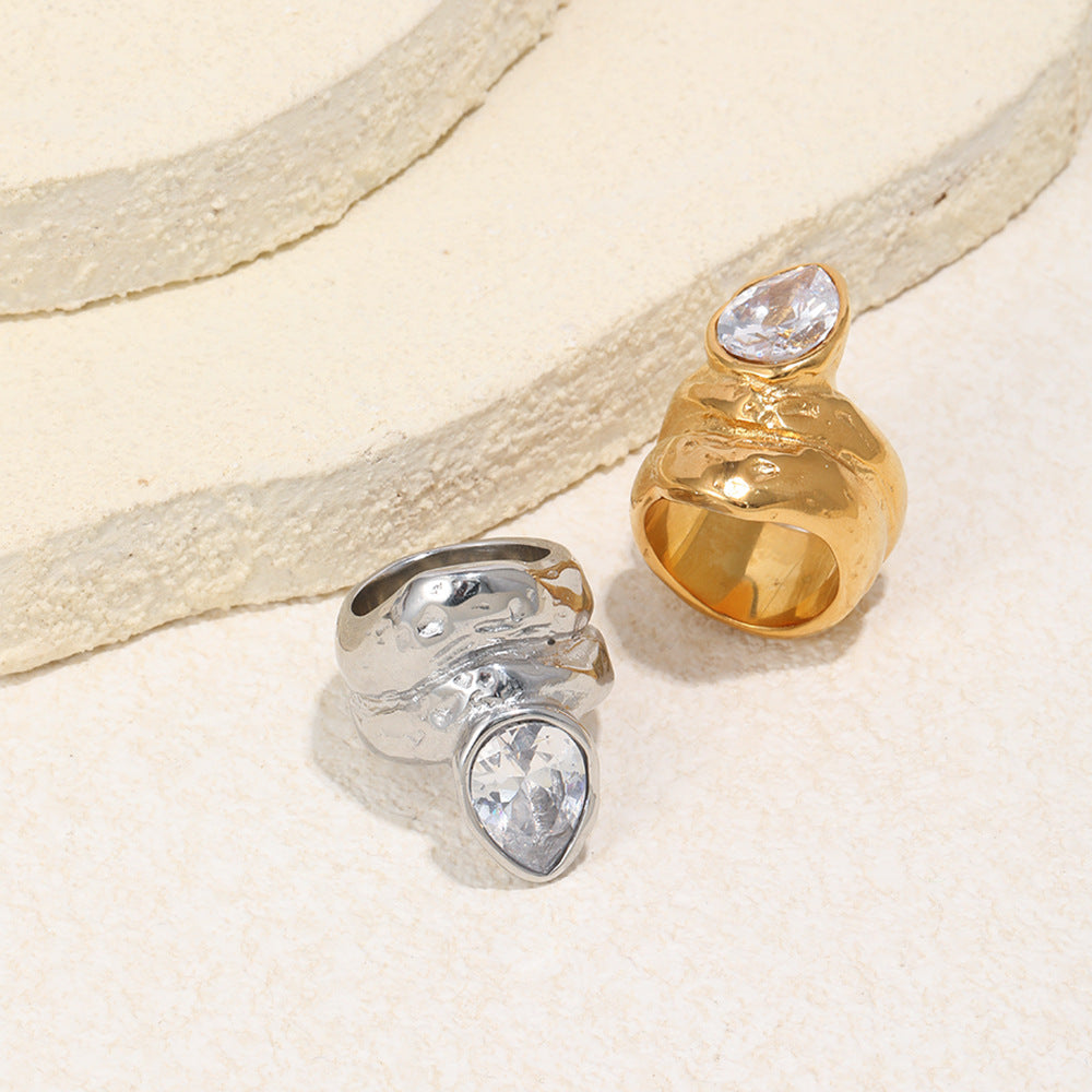 two-finish stainless steel statement rings on a stone display