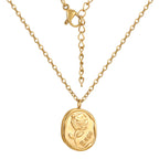 front detail of the embossed rose and word motif on the pendant