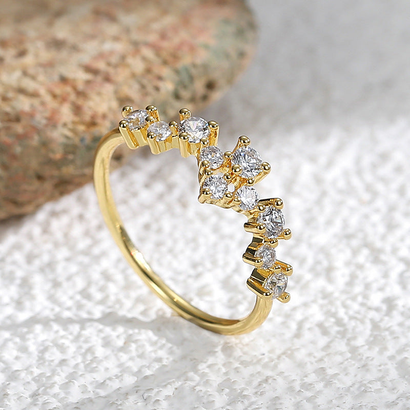 angled cluster band showing round and pear-shaped clear stones