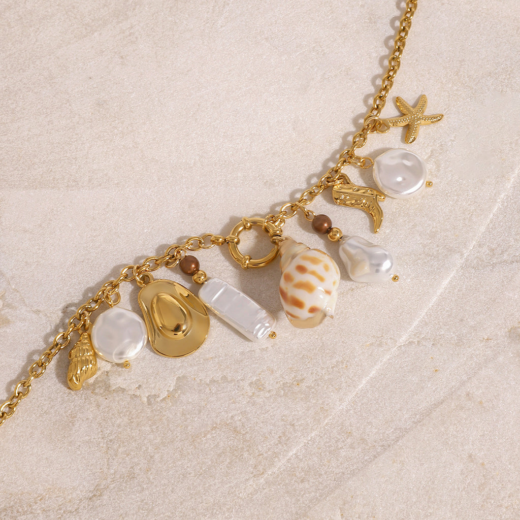 Gold-Tone Stainless Steel Ocean Charm Necklace — front view