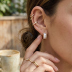 Three-stone hoop earring styled with separate ear cuffs