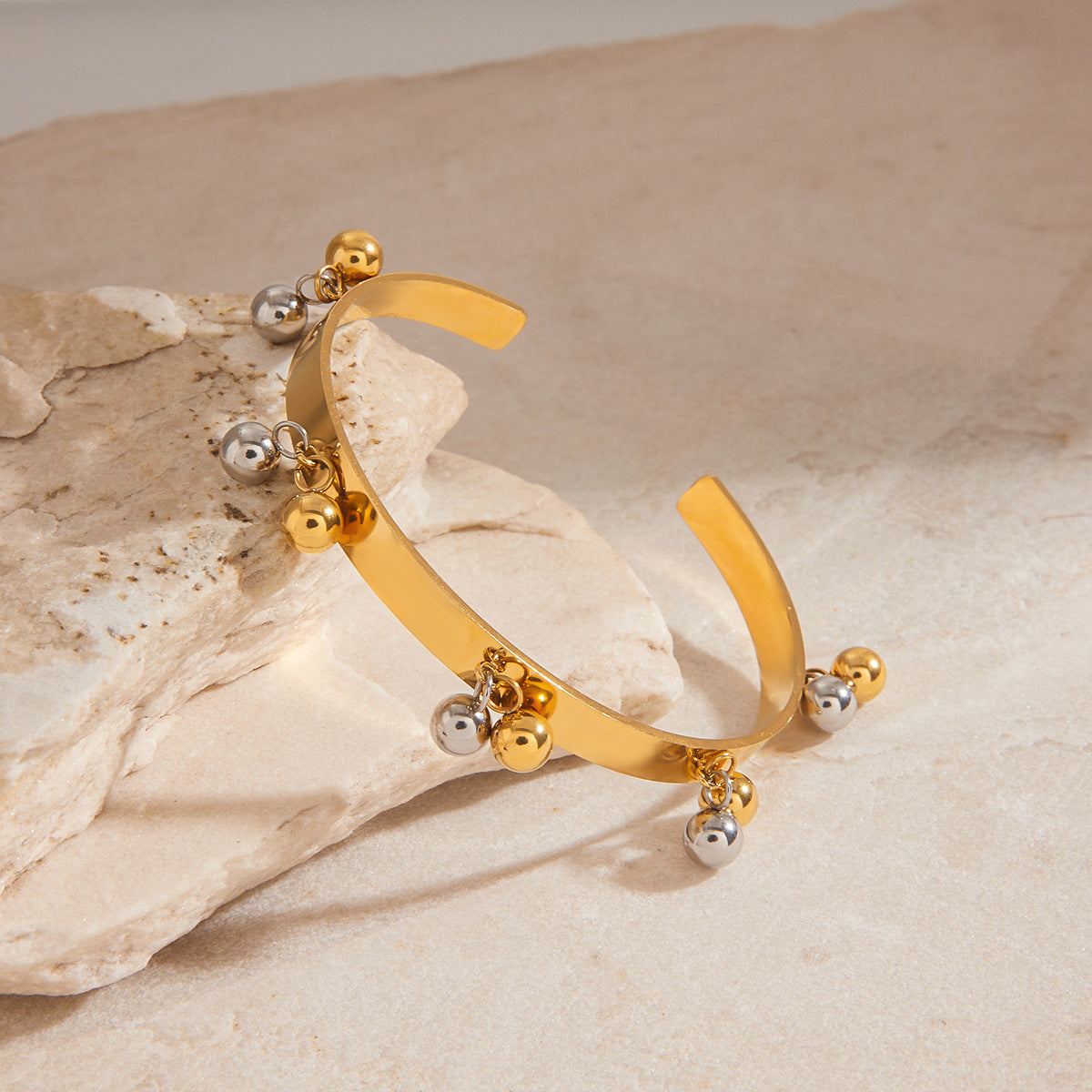 Gold plated cuff with alternating silver and gold ball charms