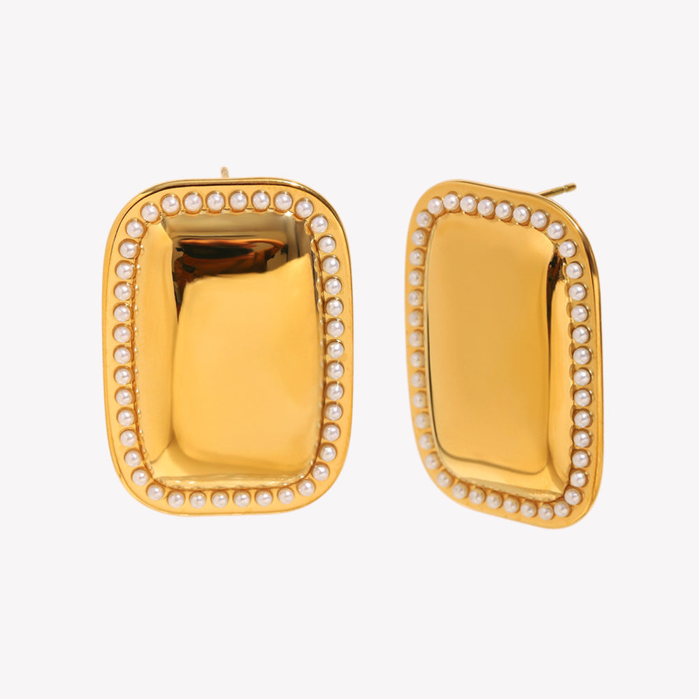 isolated front and side view of pearl-trimmed gold dome studs