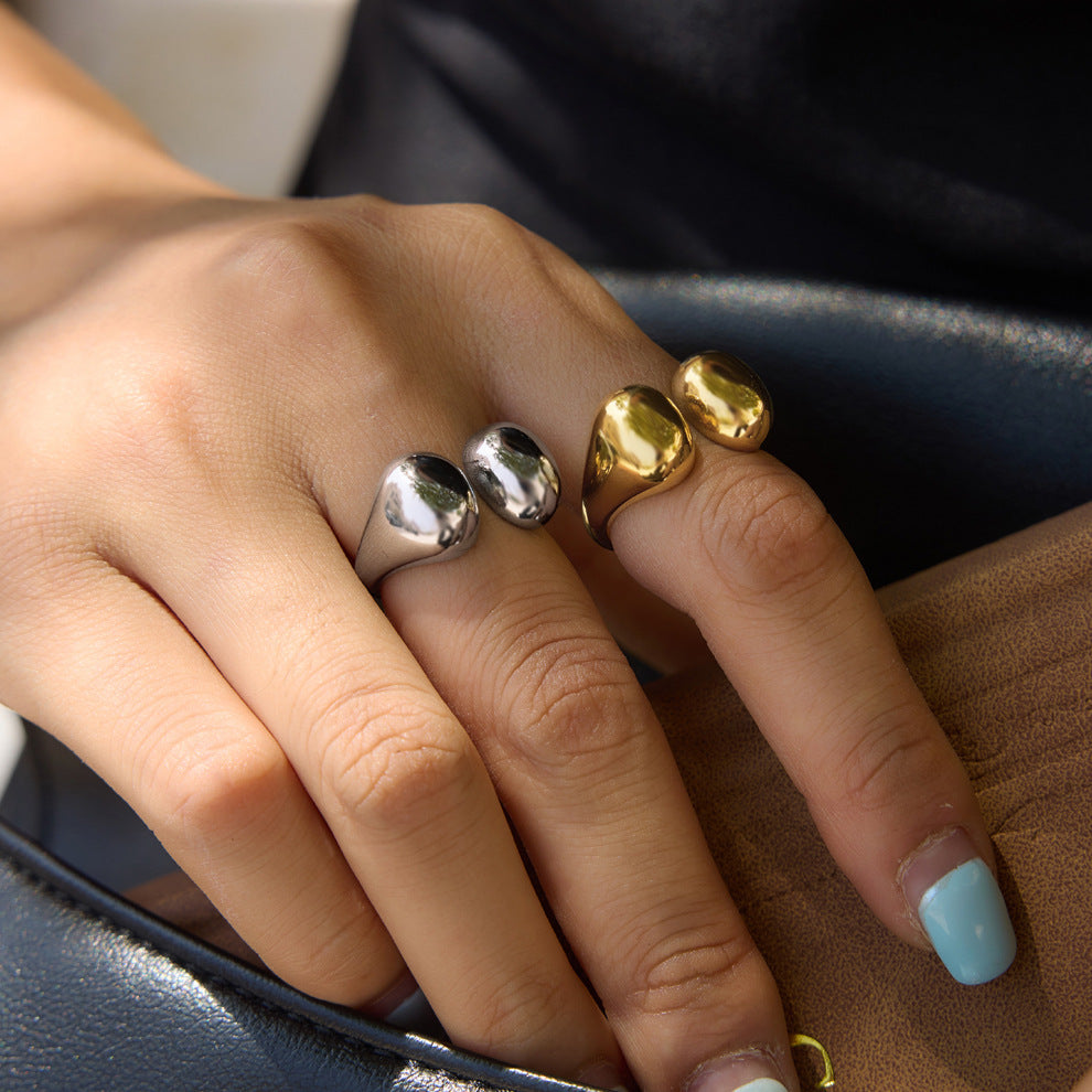 Gold tone and silver tone pebble rings worn together