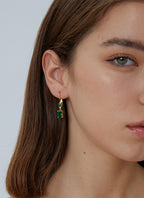 model wearing geometric green zirconia leverback earrings