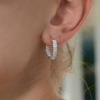close view of the square clear stones on the silver huggies