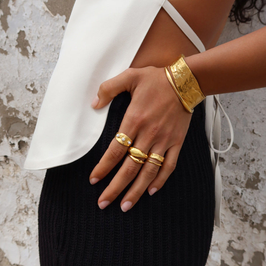 Textured pearl-look ring styled with other jewelry