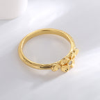 rear view of slim gold plated band and leaf-like shoulder details