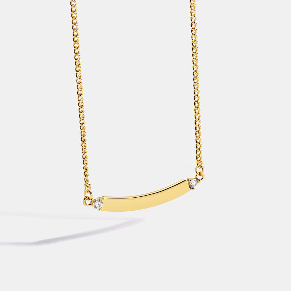 gold plated brass curved bar necklace with clear end stones
