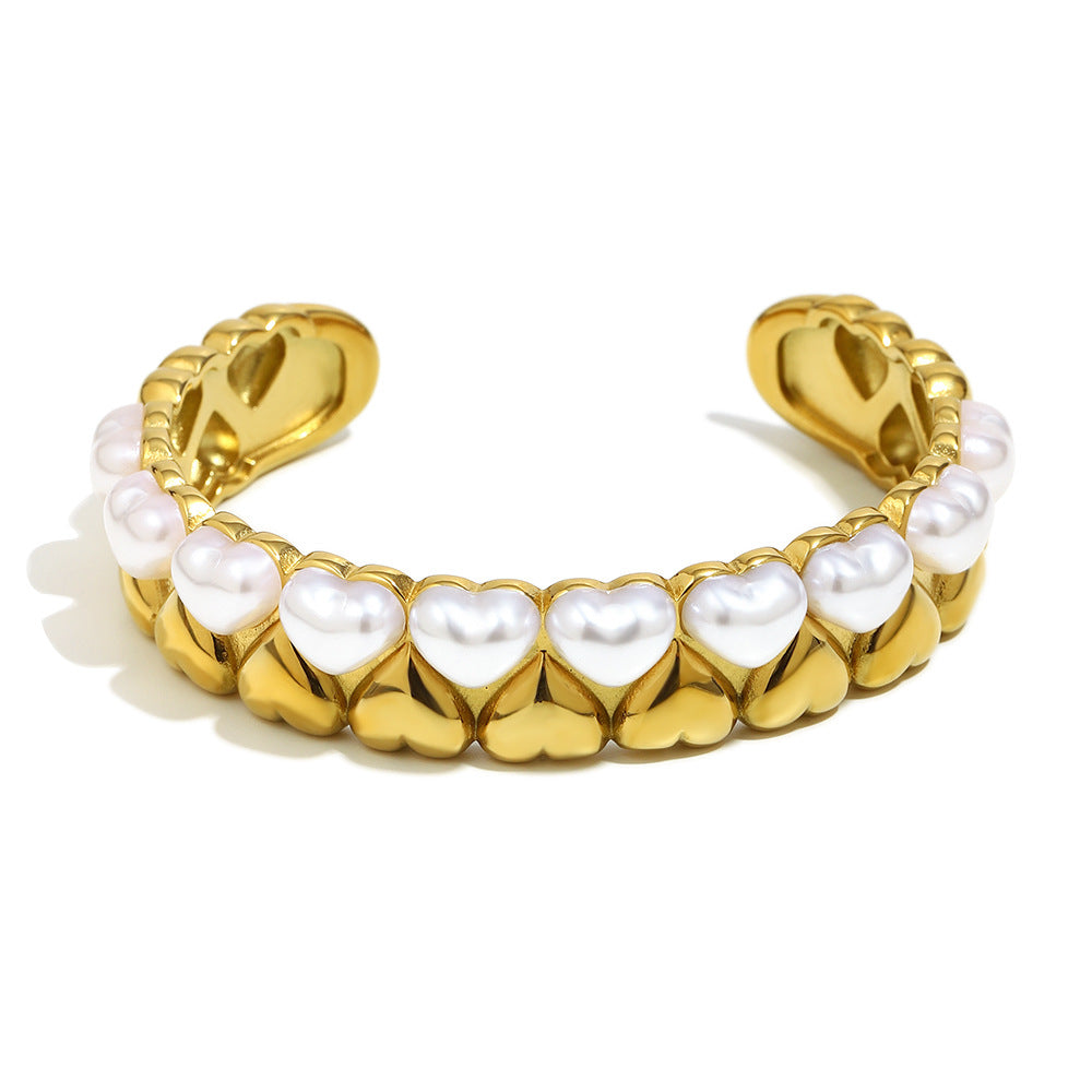 isolated catalog view of wide imitation pearl heart open cuff