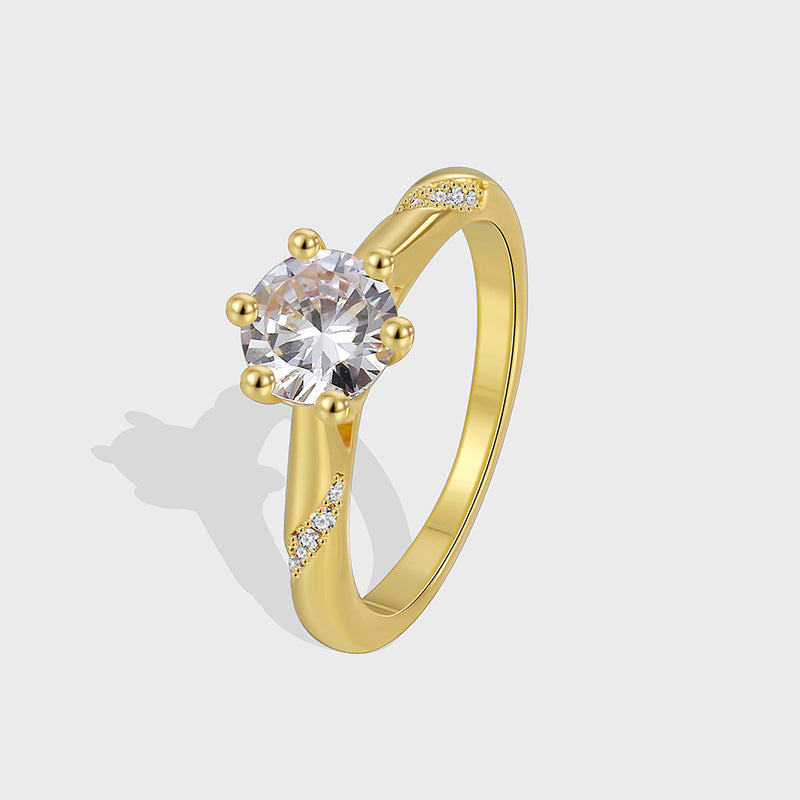 isolated six-prong clear zirconia solitaire ring in gold plated brass