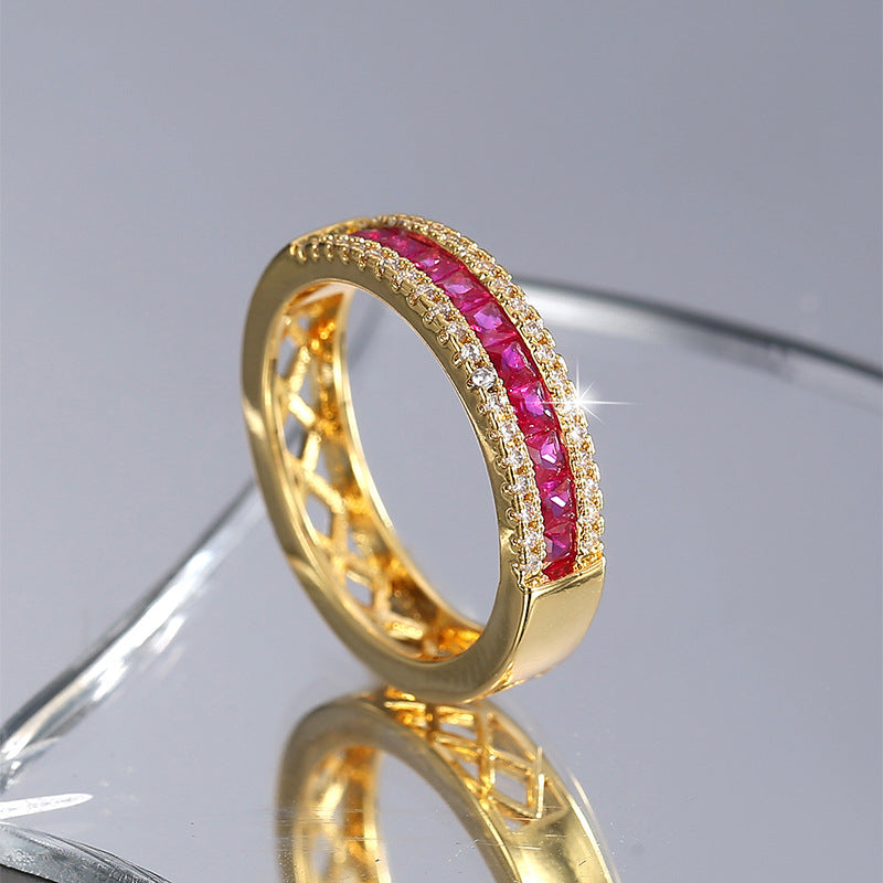upright gold plated brass band with red zirconia