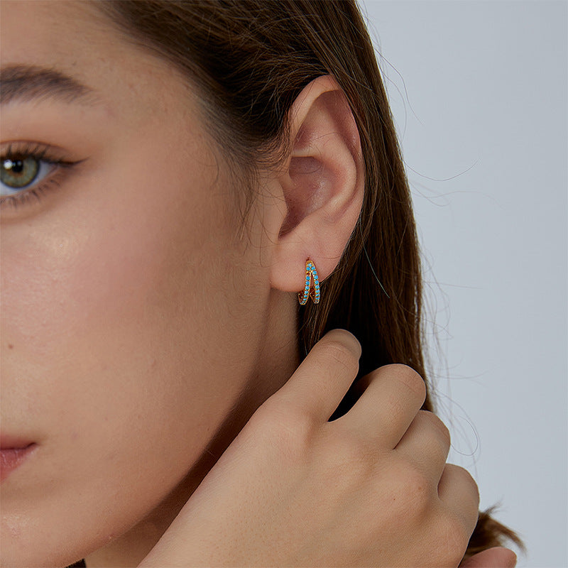 compact blue stone double-row huggie hoop worn on the ear