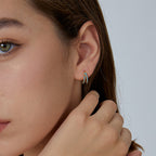 compact blue stone double-row huggie hoop worn on the ear