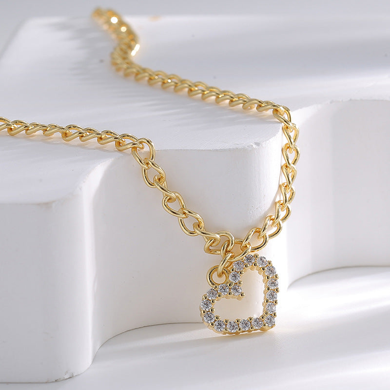 close-up of open-heart zirconia charm and curb chain