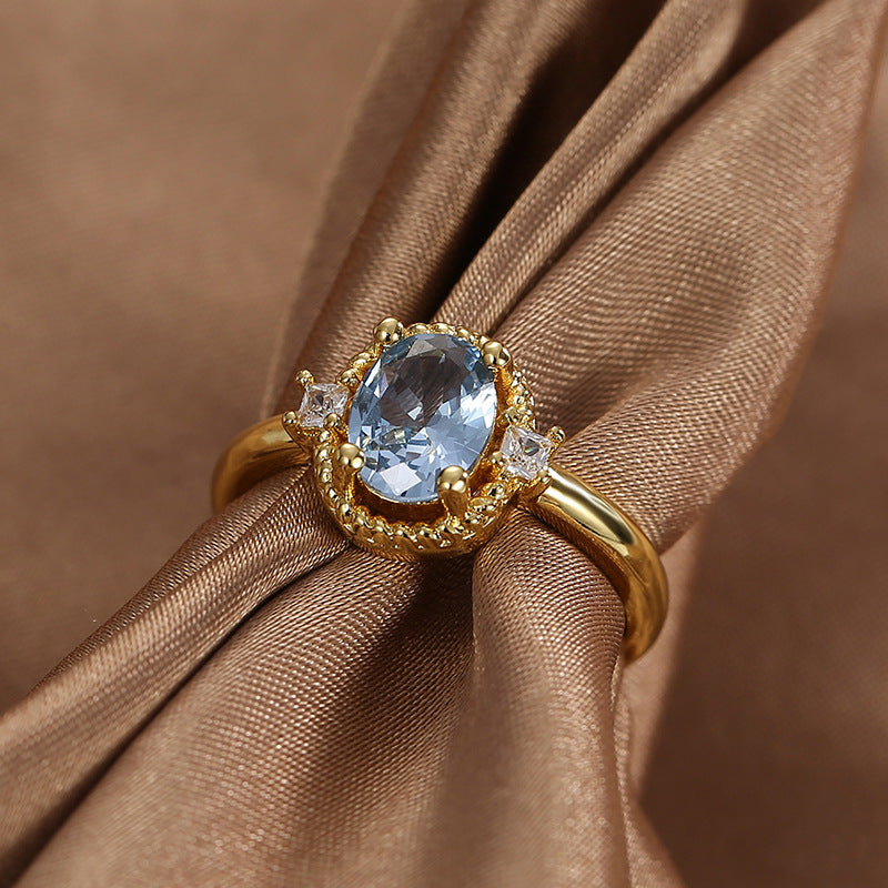 front angle of vintage-style blue zirconia and clear-stone ring