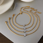 Bead bracelets arranged beside a cup