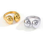 Gold tone and silver tone double pebble rings on white
