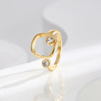 upright side view of the asymmetric two-stone open ring